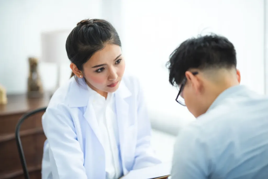 Physician listening to a patient during a consultation