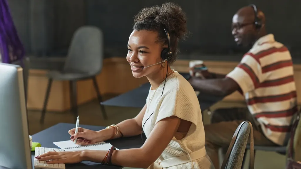 Woman with a headset taking a call at her desk