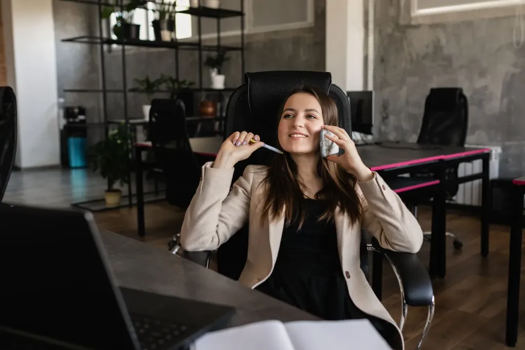 Office professional on a phone call at her desk