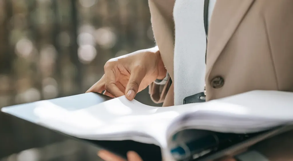 Person paging through an open reference binder