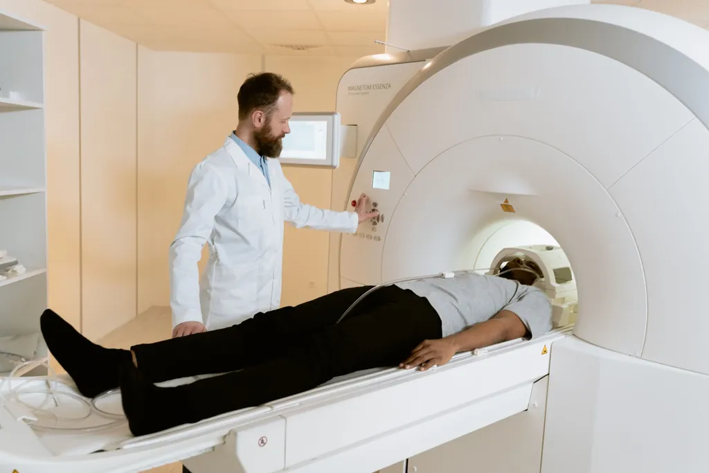 Technologist positioning a patient on an MRI scanner table