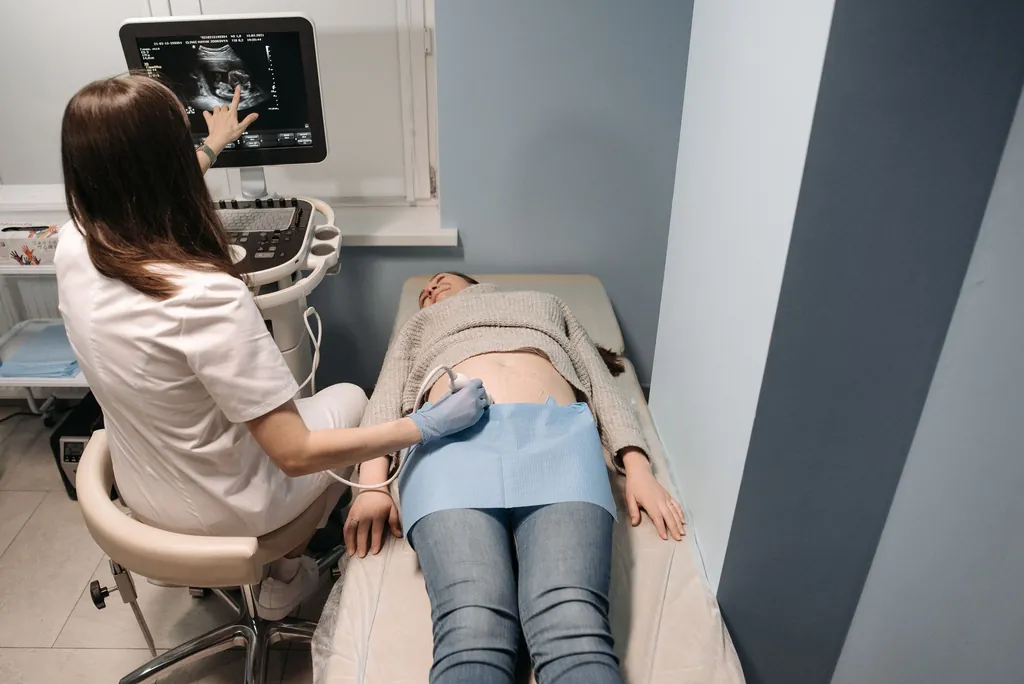 Clinician performing an ultrasound exam on a patient