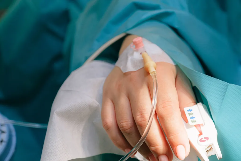 Patient's hand with an IV line and a hospital wristband