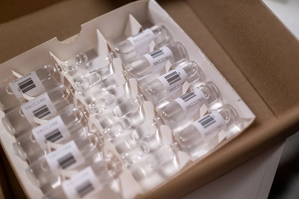 Box of small glass vials with barcode labels