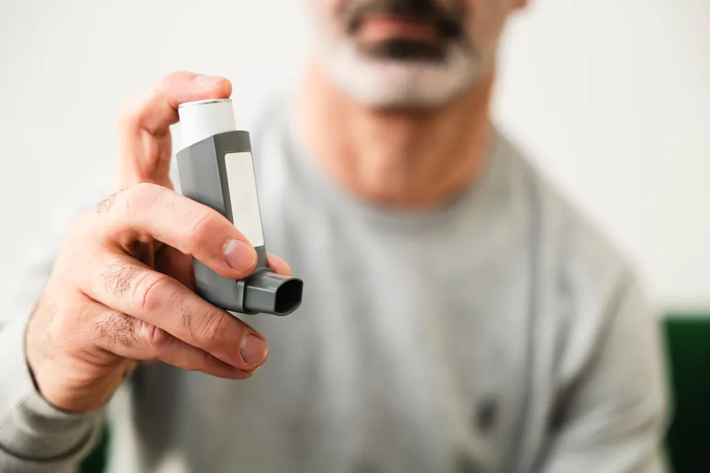 Man holding an inhaler