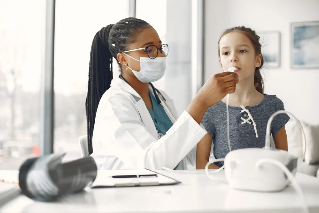 Clinician guiding a young girl through a breathing test at a desk