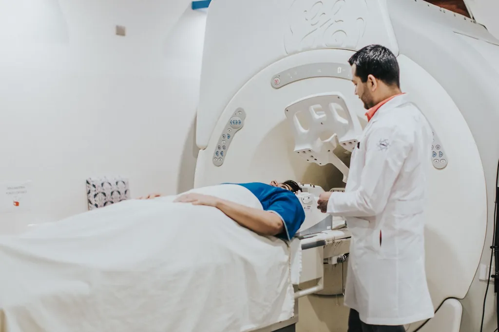 Technologist preparing a patient on an MRI scanner table