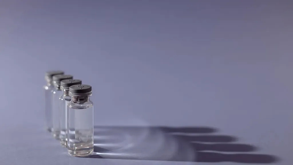 Row of small glass medication vials on a table