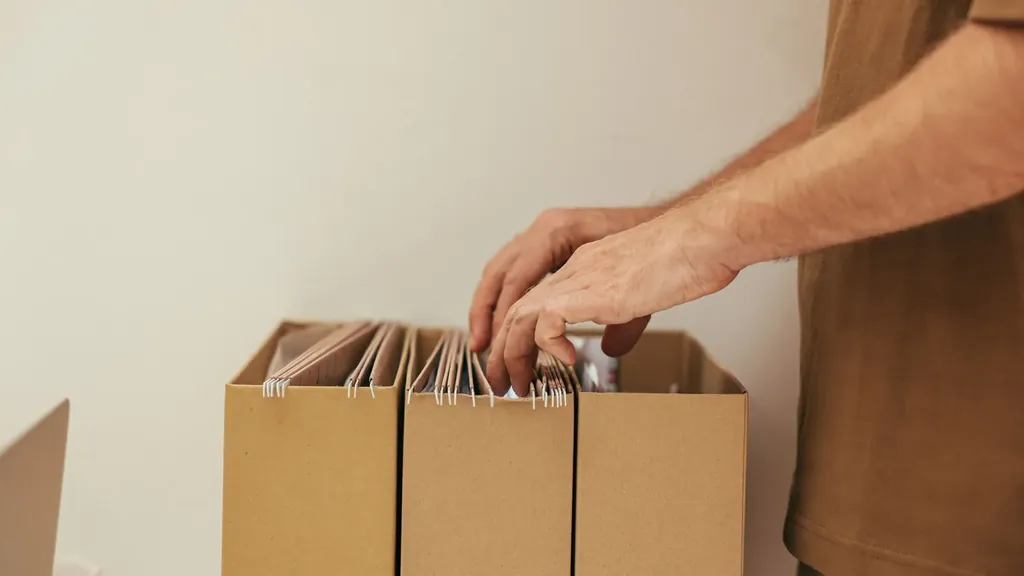 Person looking through files in cardboard organizers