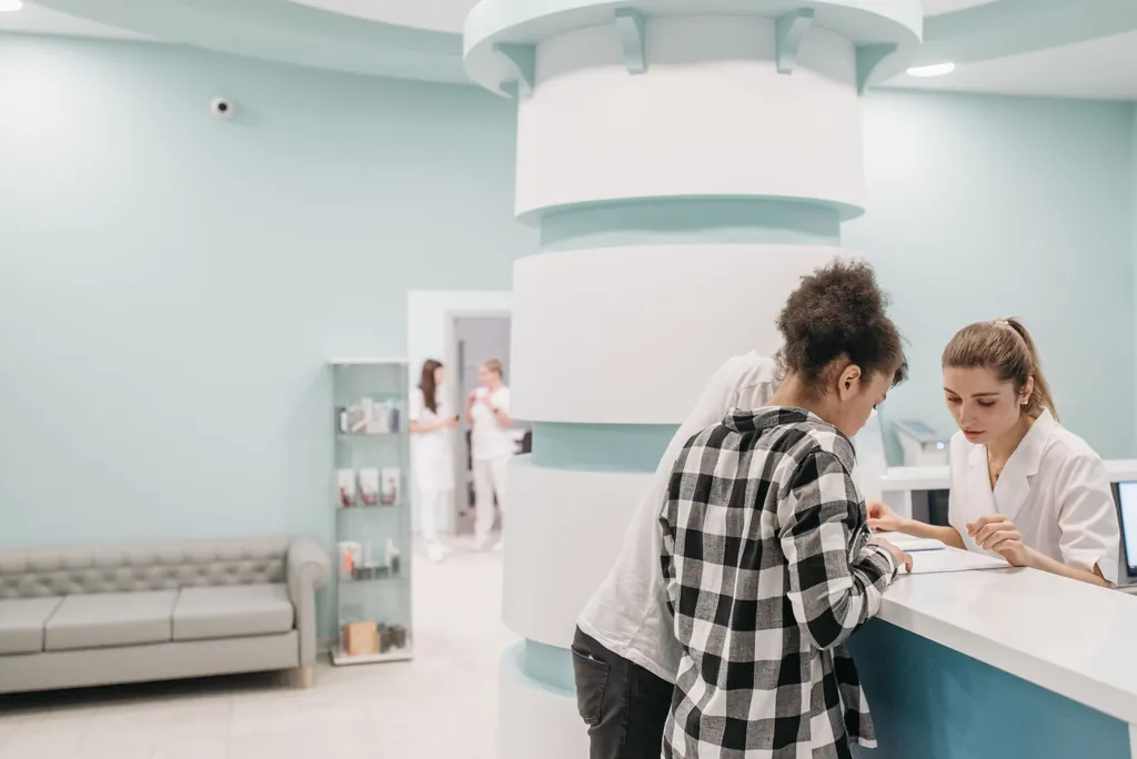 Front desk staff going over paperwork at a modern clinic reception