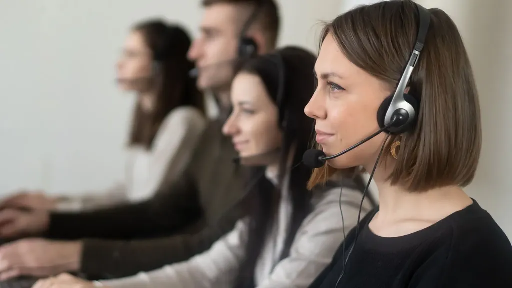 Support team with headsets working in a row