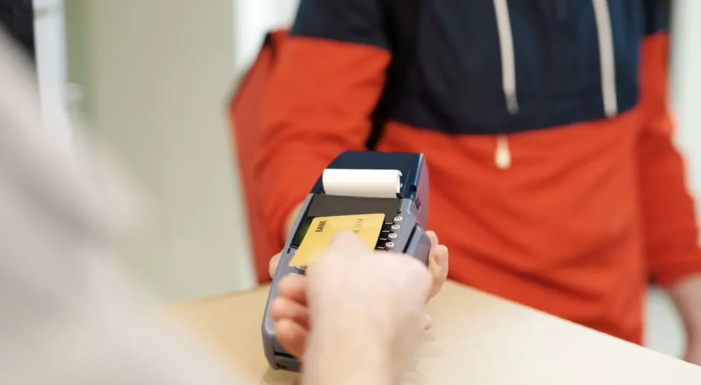 Customer holding a card payment terminal