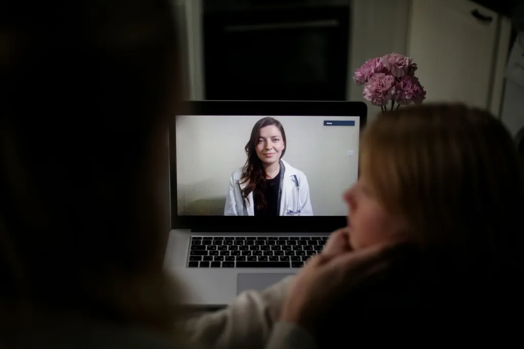 Woman at home on a laptop video consultation with a doctor